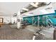 Spacious gym with workout equipment and machines against blue accent wall at 878 Peachtree Ne St # 704, Atlanta, GA 30309