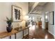 Hallway view showcasing hardwood floors leading to the living area and kitchen, complemented by tasteful decor at 878 Peachtree Ne St # 704, Atlanta, GA 30309