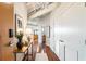 Hallway featuring hardwood floors, stylish decor, and access to various rooms including the living area and bathroom at 878 Peachtree Ne St # 704, Atlanta, GA 30309