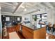 Modern kitchen featuring granite countertops, stainless steel appliances, a kitchen island, and open access to the living space at 878 Peachtree Ne St # 704, Atlanta, GA 30309