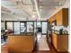 Modern kitchen features wooden cabinets, granite countertops, stainless steel appliances, and industrial-style ceiling at 878 Peachtree Ne St # 704, Atlanta, GA 30309