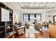 Bright living room featuring hardwood floors, exposed ductwork, modern furnishings, and large windows for plenty of natural light at 878 Peachtree Ne St # 704, Atlanta, GA 30309