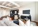 Spacious living room with modern furnishings, a large television, and ample storage space with a built-in bookcase at 878 Peachtree Ne St # 704, Atlanta, GA 30309