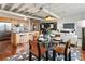 Open-concept living and dining area with hardwood floors, exposed ductwork and sleek, modern furnishings at 878 Peachtree Ne St # 704, Atlanta, GA 30309