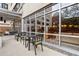 Exterior view of patio with tables and chairs, next to large windows at 878 Peachtree Ne St # 704, Atlanta, GA 30309