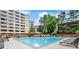 Relaxing community pool with lounge chairs surrounded by trees and modern fencing at 878 Peachtree Ne St # 704, Atlanta, GA 30309