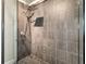 Modern shower featuring gray tile walls, a glass enclosure, and a rainfall showerhead at 878 Peachtree Ne St # 704, Atlanta, GA 30309