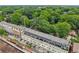 A view of luxury townhomes near lush green space and mature tree growth in a serene neighborhood setting at 190 Marion Ne Pl, Atlanta, GA 30307