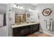Bathroom featuring double sinks, decorative Texas themed accents, and a glass-enclosed shower at 190 Marion Ne Pl, Atlanta, GA 30307