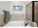 Bathroom featuring a soaking tub and a separate tiled shower with a glass door at 190 Marion Ne Pl, Atlanta, GA 30307