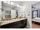 Bright bathroom with granite countertops, double sinks, and a view into the bedroom at 190 Marion Ne Pl, Atlanta, GA 30307