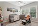 Cozy Bedroom with a gray crib, changing table, and comfortable rocking chair at 190 Marion Ne Pl, Atlanta, GA 30307