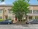 Charming brick townhome with a tree-lined street, red front door, and well-maintained landscaping at 190 Marion Ne Pl, Atlanta, GA 30307