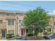 Brick townhomes with meticulously maintained landscaping and colorful front doors and mature shade tree at 190 Marion Ne Pl, Atlanta, GA 30307
