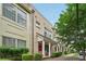 Charming brick townhouse with covered porch, manicured bushes, and lush green tree at 190 Marion Ne Pl, Atlanta, GA 30307