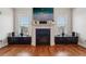 Modern living room fireplace with decorative mantle and built in storage beneath two sunlit windows at 190 Marion Ne Pl, Atlanta, GA 30307