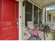 Cozy covered front porch with bright red door and comfortable seating area at 190 Marion Ne Pl, Atlanta, GA 30307