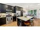 Well-lit kitchen featuring dark cabinets, hardwood floors and a granite countertop island at 190 Marion Ne Pl, Atlanta, GA 30307
