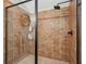 Shower featuring tile surround, glass enclosure, and built in shelving at 190 Marion Ne Pl, Atlanta, GA 30307