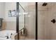 Close-up of tiled shower with glass door and rain showerhead at 190 Marion Ne Pl, Atlanta, GA 30307