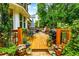 Multi-level deck featuring stylish outdoor furniture, potted plants, and a view of the lush, green backyard at 2263 Hill Creek Way, Marietta, GA 30062