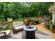 Spacious backyard with a well-maintained lawn, wooden deck, and a storage shed surrounded by lush greenery at 2263 Hill Creek Way, Marietta, GA 30062