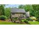Backyard features a stone patio, string lights, lawn, and landscaping for outdoor living at 2263 Hill Creek Way, Marietta, GA 30062