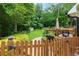 Private backyard with a well-manicured lawn, a small storage shed, wooden fence and mature trees at 2263 Hill Creek Way, Marietta, GA 30062