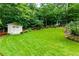 Spacious backyard features a shed, lush lawn, and mature trees for outdoor enjoyment at 2263 Hill Creek Way, Marietta, GA 30062