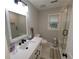 Bright bathroom featuring a modern vanity, sleek fixtures, and a glass-enclosed shower at 2263 Hill Creek Way, Marietta, GA 30062