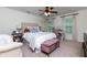Inviting bedroom with plush carpeting, a patterned comforter, and a ceiling fan at 2263 Hill Creek Way, Marietta, GA 30062