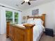 Cozy bedroom featuring a wooden bed frame, natural light, and a ceiling fan for added comfort at 2263 Hill Creek Way, Marietta, GA 30062