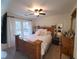 Cozy bedroom featuring a wooden bed frame, ceiling fan, and large window with backyard view at 2263 Hill Creek Way, Marietta, GA 30062