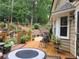 Cozy outdoor deck features comfortable seating, a fire pit table, and views of the landscaped backyard at 2263 Hill Creek Way, Marietta, GA 30062