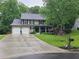 Traditional two-story home featuring a manicured lawn, a cozy front porch and a two car garage at 2263 Hill Creek Way, Marietta, GA 30062