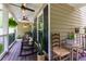 Spacious front porch with rocking chairs, ceiling fans, and outdoor furniture at 2263 Hill Creek Way, Marietta, GA 30062