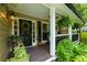 A charming front porch features black door, green plants, and outside lighting at 2263 Hill Creek Way, Marietta, GA 30062