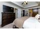 Bright bedroom boasting a dark wood dresser, walk-in closet, ceiling fan, and a sliding barn door at 2263 Hill Creek Way, Marietta, GA 30062