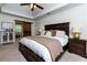 Spacious bedroom with a barn door to bathroom, a dark wood bed, and neutral tones at 2263 Hill Creek Way, Marietta, GA 30062