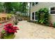 Paver patio with lush landscaping and vibrant flowers creates a tranquil outdoor living space at 2263 Hill Creek Way, Marietta, GA 30062