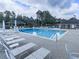 A full view of the neighborhood pool, chairs and tables on the concrete deck at 2263 Hill Creek Way, Marietta, GA 30062