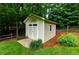 Backyard shed with double doors, window, and neutral color siding at 2263 Hill Creek Way, Marietta, GA 30062