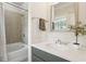 Updated bathroom featuring a modern vanity, decorative mirror and shower-tub combination at 306 Masons Row, Marietta, GA 30060
