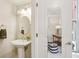 Charming powder room featuring a pedestal sink and a glimpse into a stylish office space at 306 Masons Row, Marietta, GA 30060