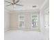 Bright bedroom featuring a ceiling fan, fresh paint, and natural light from two windows at 306 Masons Row, Marietta, GA 30060