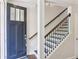 Inviting foyer with a wood-trimmed staircase and a stylish front door with glass panels at 306 Masons Row, Marietta, GA 30060