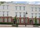 Attractive townhome featuring a brick base, multiple windows, and well-maintained greenery at 306 Masons Row, Marietta, GA 30060