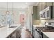 Modern kitchen with stainless steel appliances, gray cabinets, and a spacious countertop island at 306 Masons Row, Marietta, GA 30060