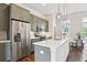 Well-lit kitchen with stainless steel appliances, gray cabinets, and a large white countertop island at 306 Masons Row, Marietta, GA 30060