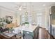 Open-concept living space with kitchen island, pendant lighting, and comfortable seating area at 306 Masons Row, Marietta, GA 30060